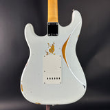 White electric guitar with gold accents on a dark background