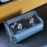 Fender guitar pedal with two switches on a textured surface