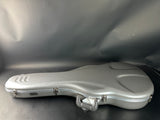 Silver guitar case on a gray background