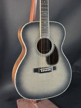 Acoustic guitar with a dark finish on a black background