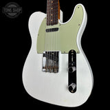 A white electric guitar with a light green pickguard and a dark fretboard, shown against a solid black background. A Tone Shop watermark is visible in the top-left corner.