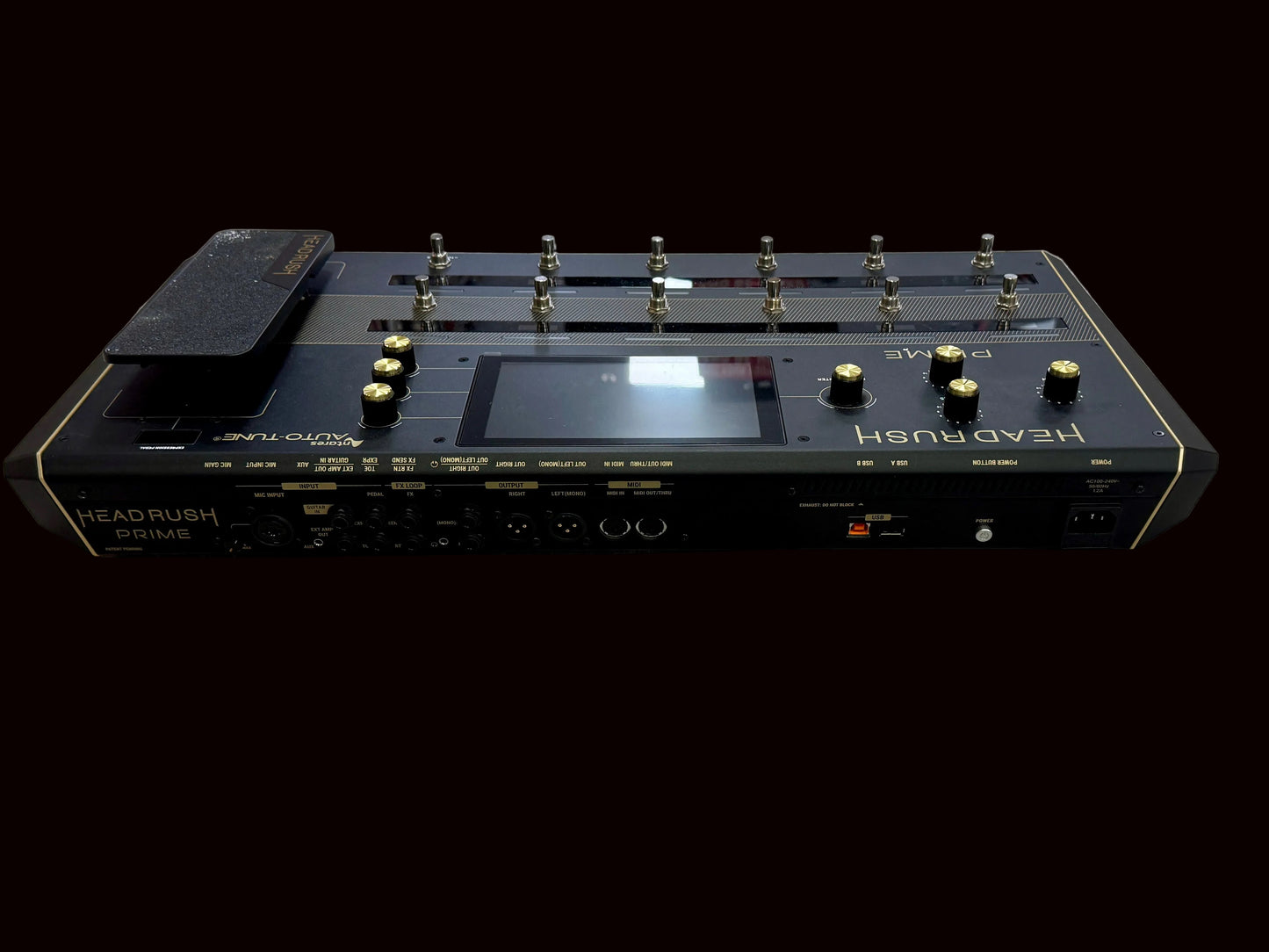 Black electronic device with buttons and display on a wooden surface