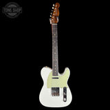 A classic Fender Telecaster electric guitar with a white body, pale green pickguard, and brown wood neck, shown against a solid black background with a Tone Shop watermark in the top left corner.