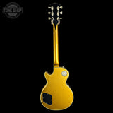 A gold-finish electric guitar shown from the back against a solid black background, with a Tone Shop watermark in the upper left corner.