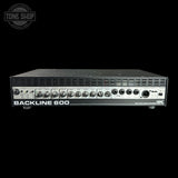 A Backline 600 speaker amplifier shown from the front against a solid black background, with a Tone Shop watermark in the upper left corner.