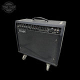 A Boogie guitar amplifier with a black textured cabinet, front speaker grille, and top carry handle, shown on a black background with a Tone Shop watermark in the upper left.