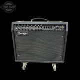 A Boogie W2500 guitar amplifier with a black textured grille, black control panel with knobs, and gray wheels, shown against a solid black background.