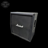 A vintage Marshall guitar amplifier cabinet in black textured fabric with the white Marshall logo on the front, shown at an angle against a black background with a Tone Shop watermark in the top left.