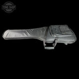 A dark gray padded guitar or bass gig bag with a zippered side pocket, shown against a solid black background. A Tone Shop watermark is visible in the top-left corner.