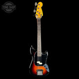 A classic Fender Stratocaster-style bass guitar with a sunburst finish, black pickguard, and a bright yellow headstock, shown against a solid black background with a Tone Shop watermark in the top left.