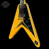 Yellow electric guitar with black pickguard on a black background, featuring 'Tone Shop' logo.