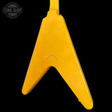 Yellow guitar pickguard with 'Tone Shop' logo in the corner