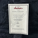 Jackson Custom Shop certificate on a textured black surface