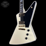 White electric guitar with black pickguard on a black background, featuring 'Tone Shop' logo.