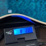 Ernie Ball Music Man 30th Anniversary Axis Translucent Blue Quilt on scale displaying weight.