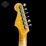 Guitar headstock with tuning pegs on a black background, featuring 'Tone Shop' logo.