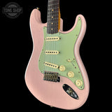 Pink and green electric guitar with 'Tone Shop' logo in the corner.