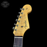 Close-up of a Fender electric guitar headstock on a black background