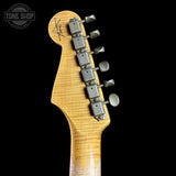 Guitar headstock with tuning pegs on a black background, featuring the Tone Shop logo.