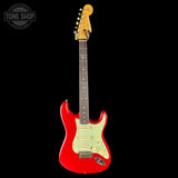 Red electric guitar with a white pickguard on a black background, featuring 'Tone Shop' branding.