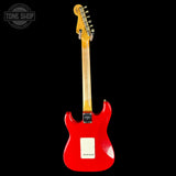 Red electric guitar with a black background
