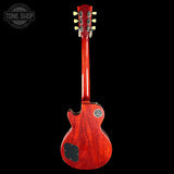 A red Gibson Les Paul Custom electric guitar shown from the back, featuring a glossy reddish-brown cherry wood finish, cream tuning pegs, and a black pickguard, set against a solid black background with a Tone Shop watermark in the top left.