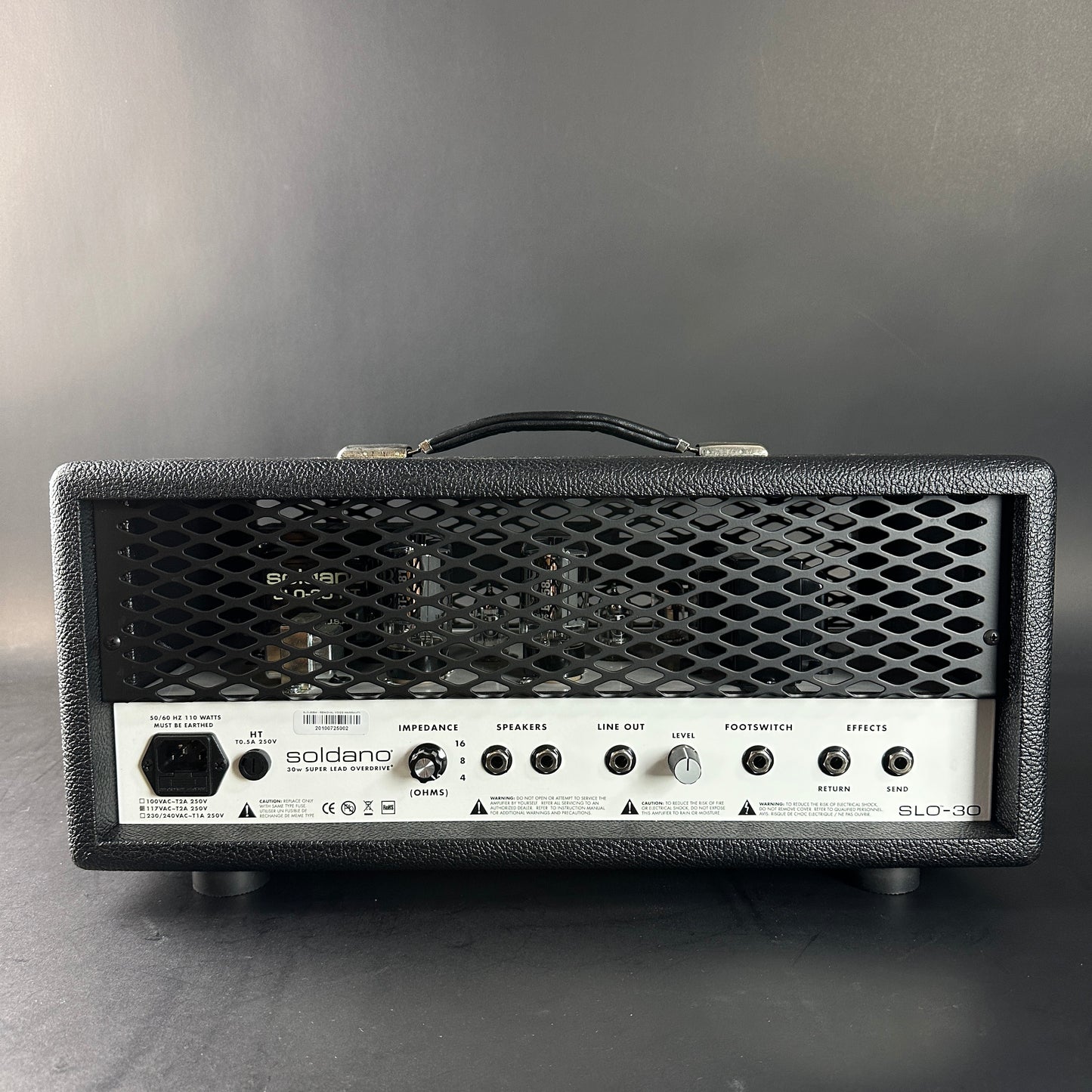 Guitar amplifier head with visible branding on a gray background