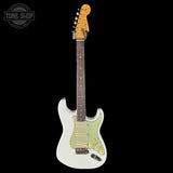 Electric guitar with a white body and green pickguard on a black background, featuring the Tone Shop logo.