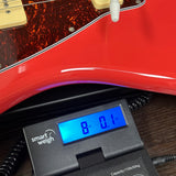 Used Tagima TW-61 on scale displaying weight.