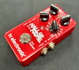Red guitar effects pedal with 'Wall of Sound' branding on a gray background