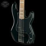 A black electric bass guitar with a maple neck, chrome hardware, and white pickguard details, shown against a solid black background with a Tone Shop logo in the top-left corner.