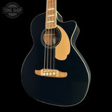 A black acoustic-electric cutaway guitar with a natural wood body, soundhole surround, bridge, and neck, shown against a solid black background. A Tone Shop watermark is visible in the top-left corner.