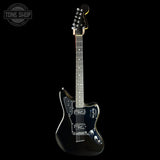 A black electric guitar with a glossy finish, shown from the front against a solid black background. A Tone Shop watermark is visible in the top-left corner.