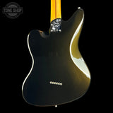 The back of a Fender electric guitar body in glossy black with a maple neck, shown against a solid black background. A Tone Shop watermark is visible in the top-left corner.