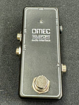 OMEC Teleport audio interface on a dark textured background