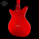 The rear view of a red electric guitar body with chrome hardware, shown against a solid black background with a Tone Shop watermark in the top left corner.