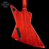 The back of a custom electric guitar featuring a vibrant red cherry wood finish with prominent wood grain, shown against a solid black background.