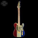 A custom electric guitar with a glittery red, white, and blue vertical stripe design on the body, set against a solid black background. A Tone Shop watermark is visible in the top-left corner.
