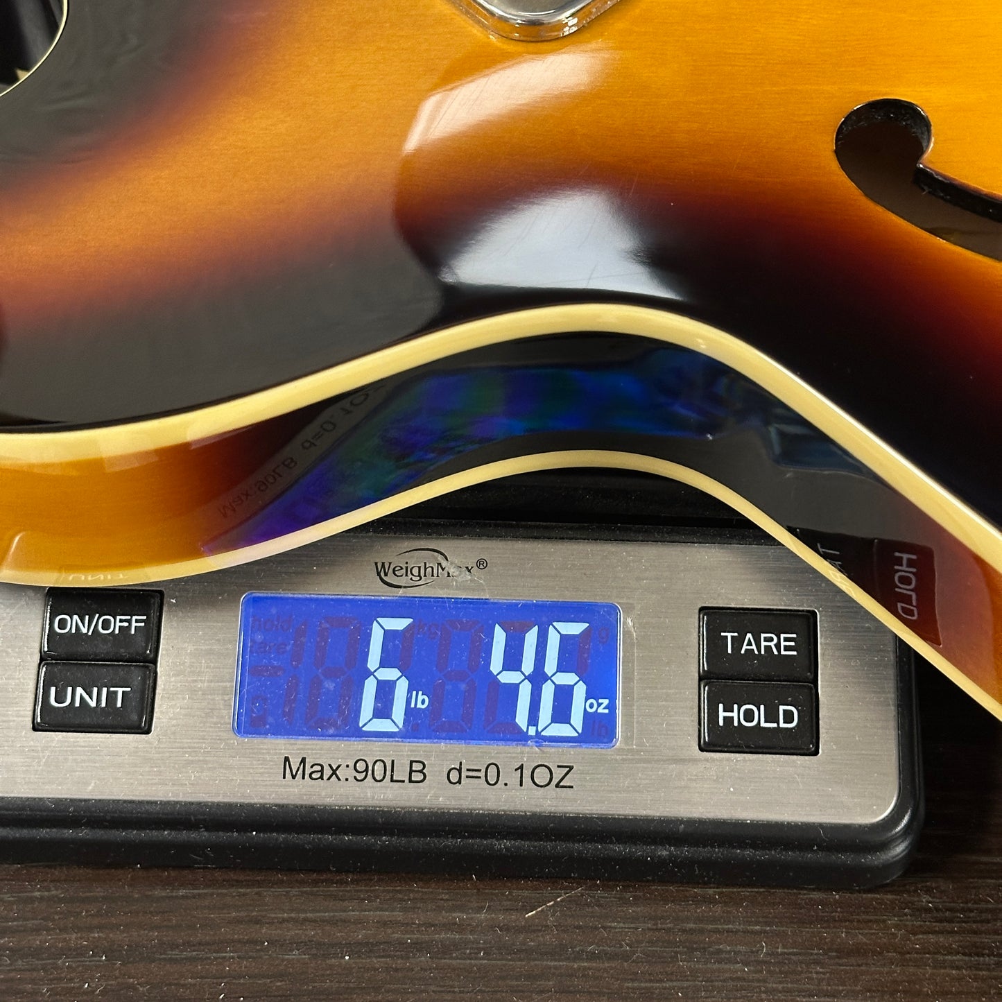 Guitar on a digital scale displaying weight