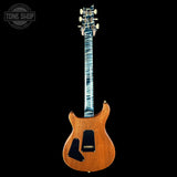 A classic electric guitar with a natural wood body and a distinctive blue-and-white marbled maple neck, shown against a solid black background. A 'TONE SHOP' watermark is visible in the top-left corner.