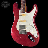 A red glitter electric guitar with a white pickguard, shown against a solid black background. The brand logo on the headstock is not visible, and there is a 'TONE SHOP' watermark in the top-left corner.