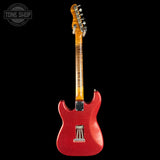A red glitter electric guitar shown from the back against a solid black background, featuring a flamed maple neck and a Tone Shop logo watermark in the top left corner.