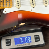 Guitar on a digital scale displaying weight