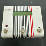 Guitar effects pedal with striped design on a dark background