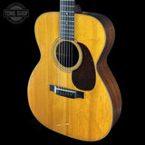 Acoustic guitar with a visible brand logo in the corner