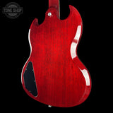 The rear view of a Gibson SG electric guitar with a glossy red cherry finish, shown against a solid black background. A Tone Shop watermark is visible in the top-left corner.