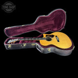 Acoustic guitar in a case with 'Tone Shop' logo in the corner