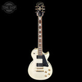 A white Gibson Les Paul Custom electric guitar with gold hardware and a black pickguard, shown against a solid black background. A 'TONE SHOP' watermark is visible in the top-left corner.