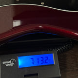 Used G&L Legacy Burgundy on scale displaying weight.