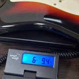 Used 2016 Squier Classic Vibe 60's Stratocaster Sunburst on scale displaying weight.